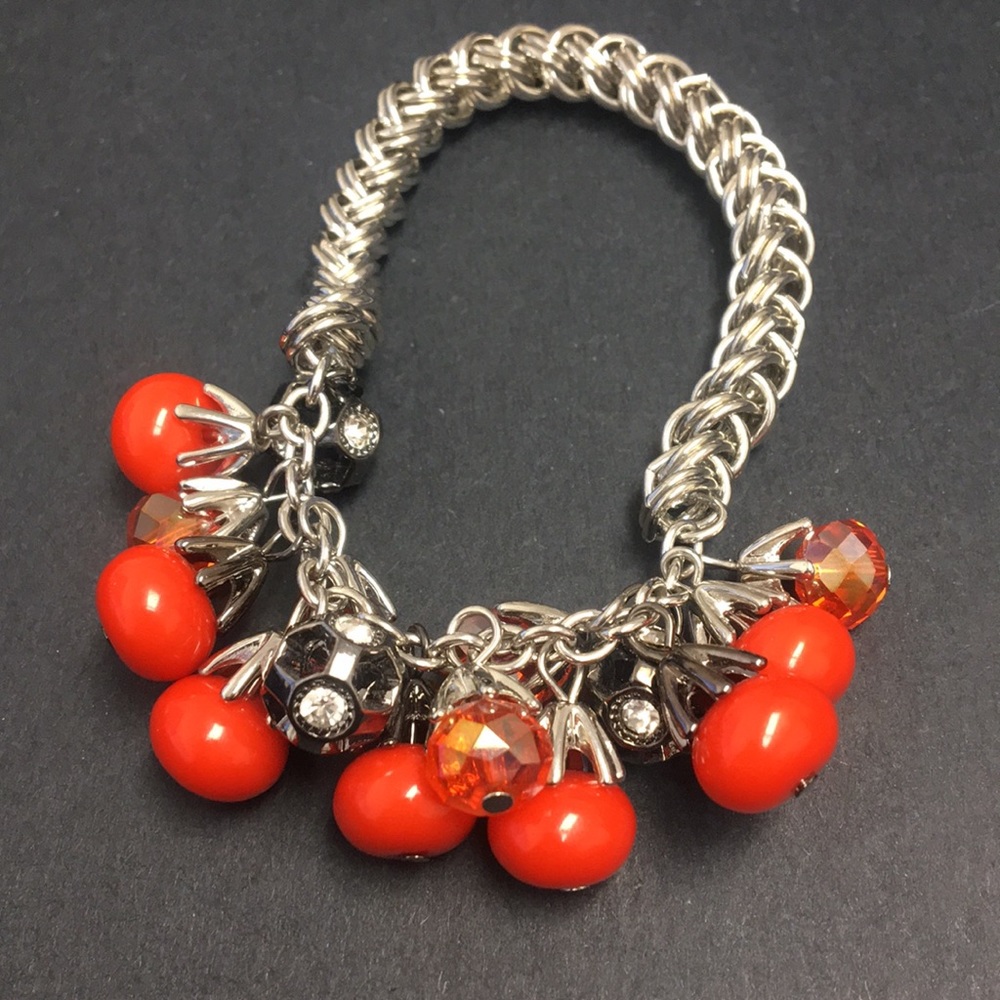 Stretch bracelet with orange dangle charms